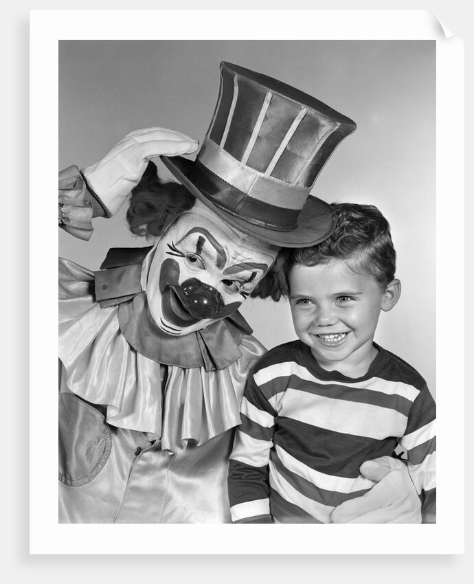 1950s smiling clown with top hat arm around grinning boy in striped shirt by Anonymous