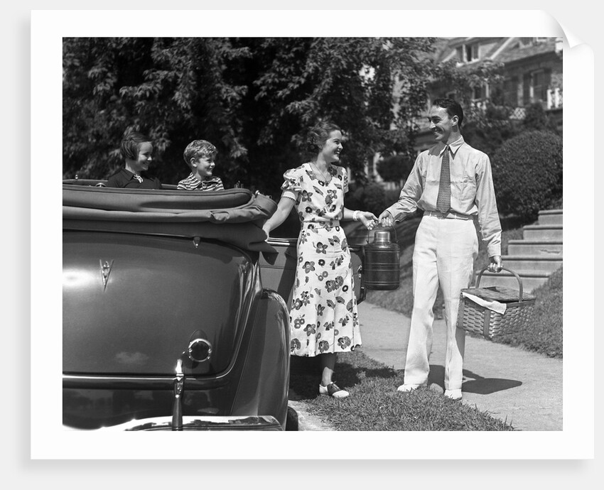 1930s family of four getting into convertible automobile with picnic basket and thermos jug by Anonymous