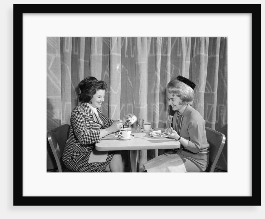 1960s two women having lunch in coffee shop restaurant by Anonymous