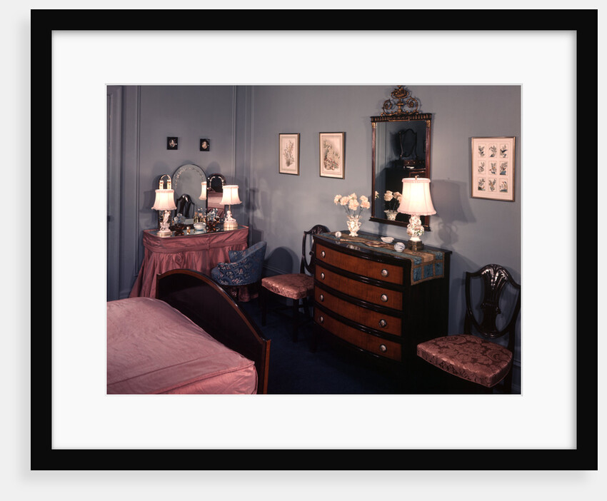 1930s 1940s bedroom with blue walls pink bedspread and skirted vanity table by Anonymous