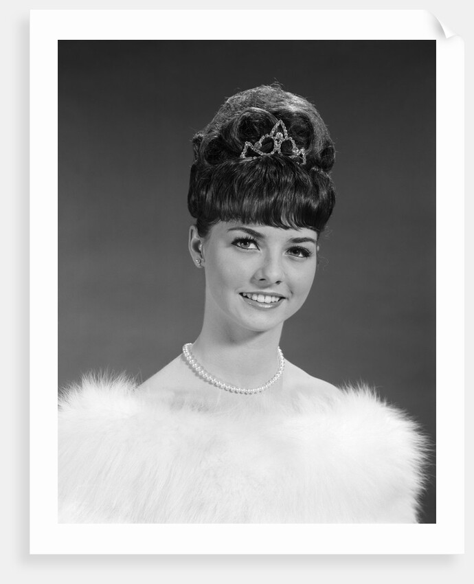 1960s pretty young woman wearing tiara fur stole and string of pearls looking at camera by Anonymous