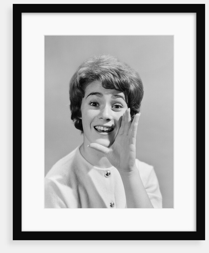 1950s woman yelling with hand held up to her face by Anonymous