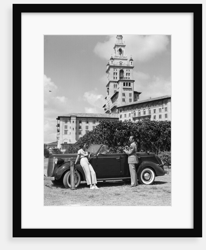 1930s couple with golf clubs standing by a car in front of the biltmore hotel miami florida by Anonymous