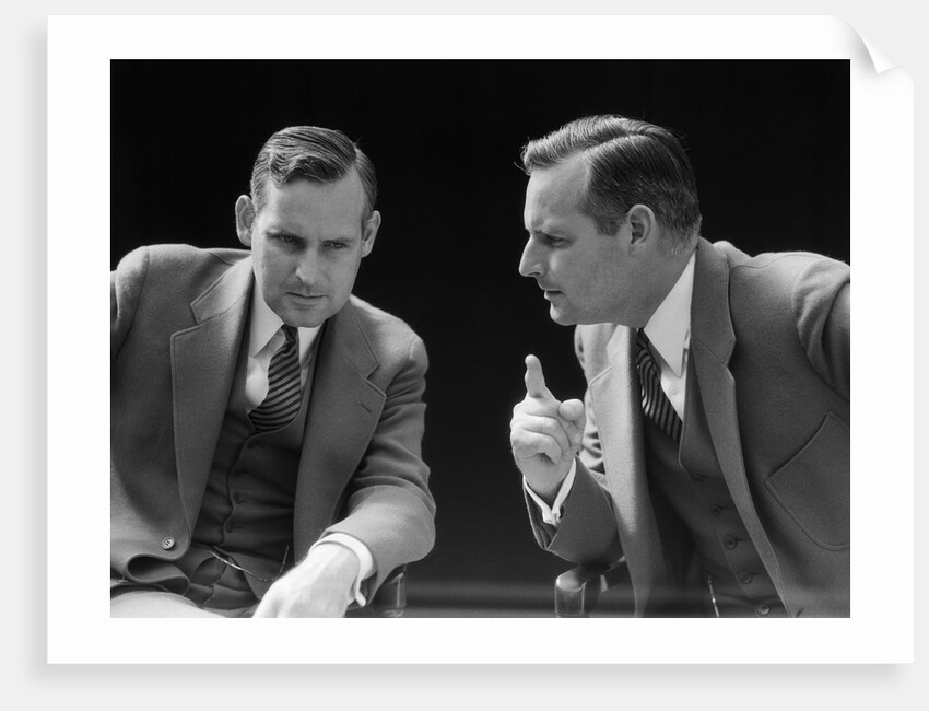 1930s 1940s businessman talking seriously to himself or his twin alter ego by Anonymous