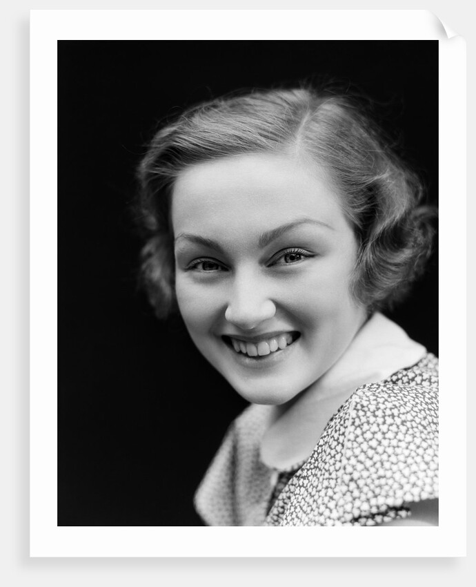 1930s portrait happy young brunette woman wearing print blouse with white collar smiling looking at camera by Anonymous