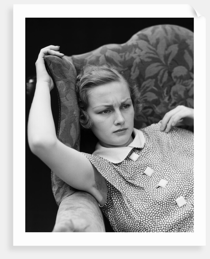 1930s woman sitting slumped position with a worried expression and a furrowed brow by Anonymous