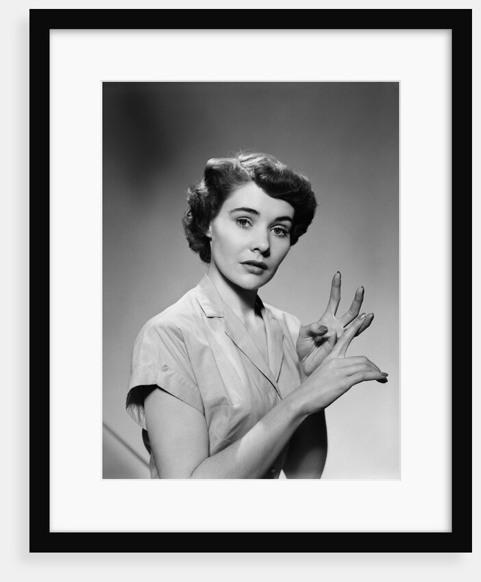 1950s serious woman counting on hands by Anonymous