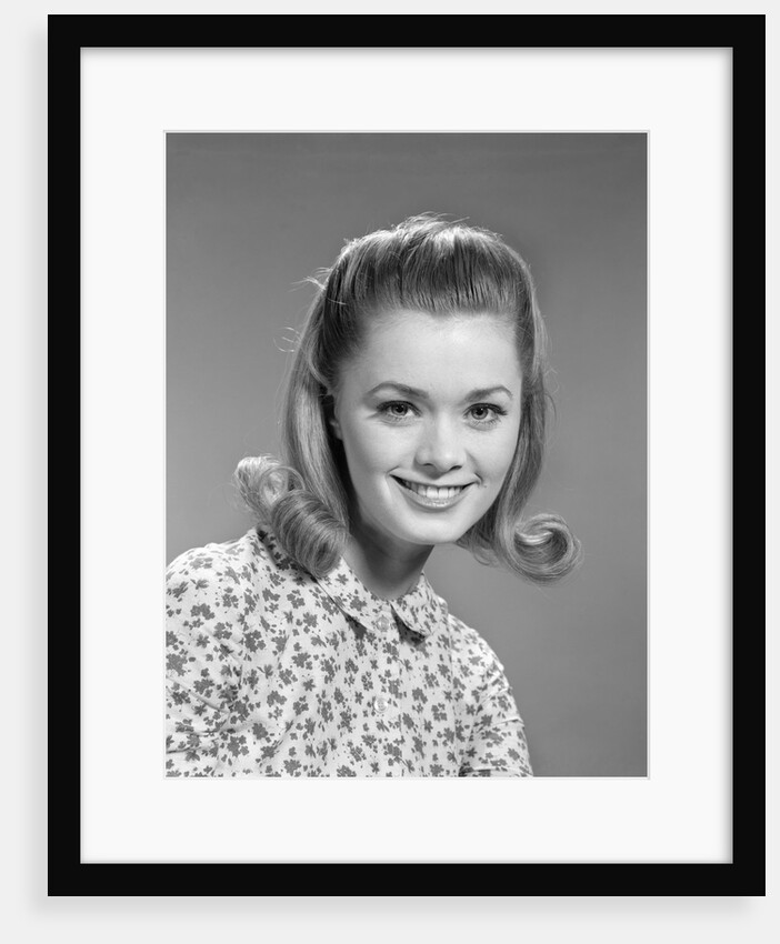 1960s portrait smiling woman wearing print blouse with flip hairdo by Anonymous