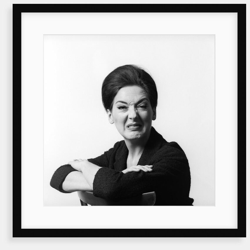 1960s 1970s brunette middle aged woman making funny face looking at camera with wrinkled nose and arms folded on back of chair by Anonymous