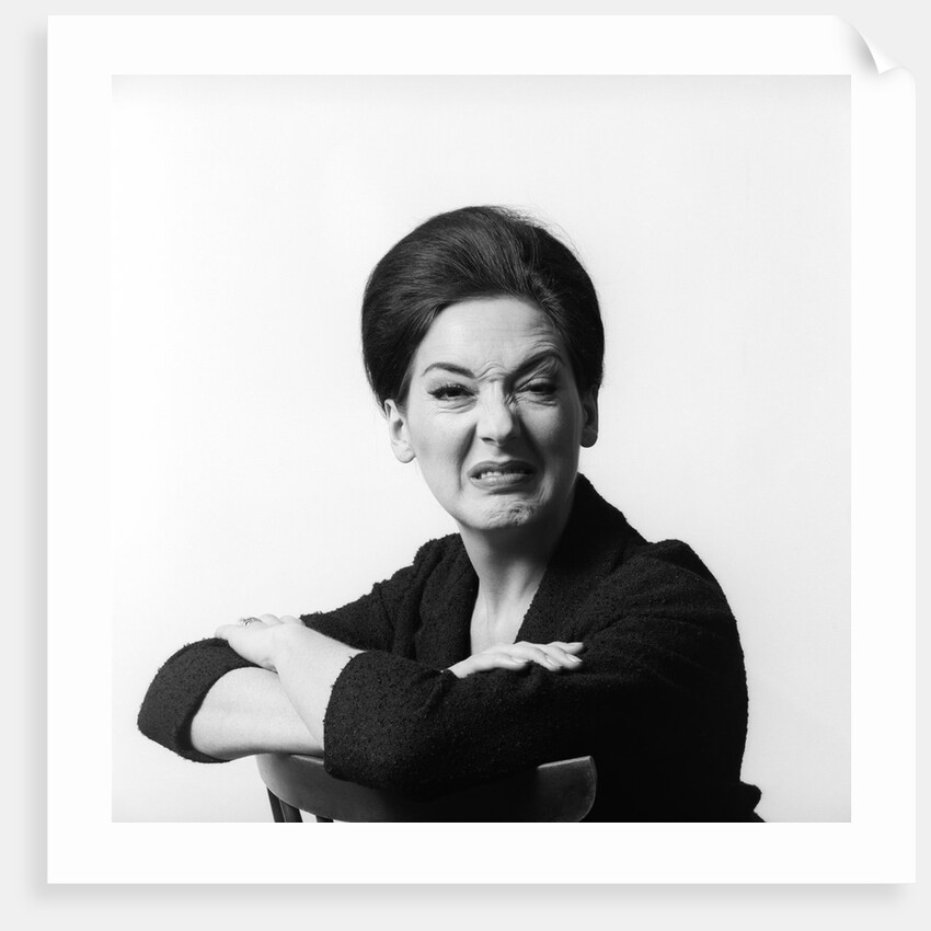 1960s 1970s brunette middle aged woman making funny face looking at camera with wrinkled nose and arms folded on back of chair by Anonymous