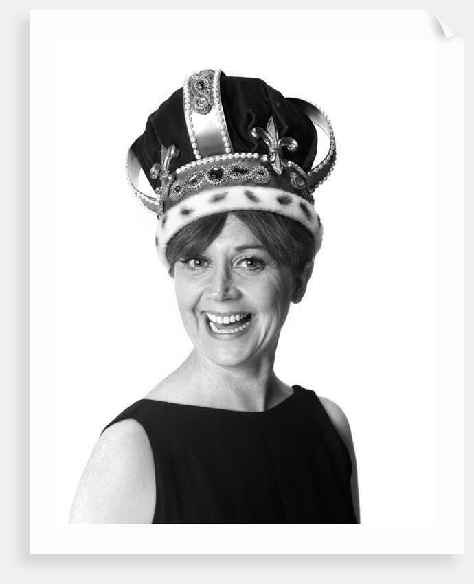 1970s smiling portrait woman wearing queen's crown looking at camera by Anonymous