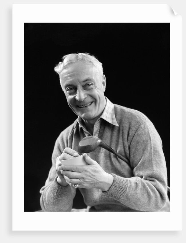 1920s smiling man marking golf club scorecard looking at camera by Anonymous