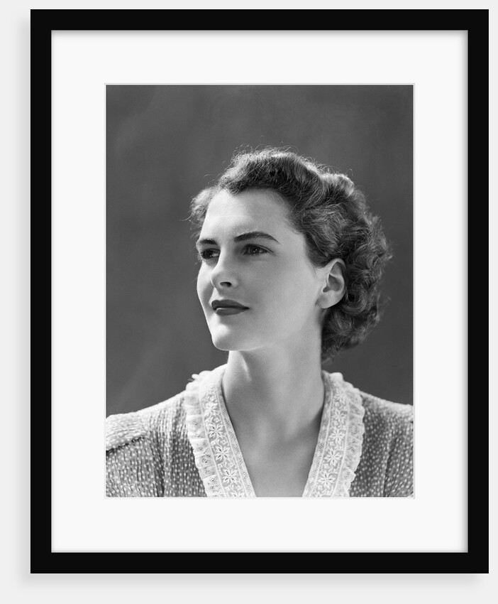 1940s profile portrait brunette woman wearing print dress with lace collar by Anonymous
