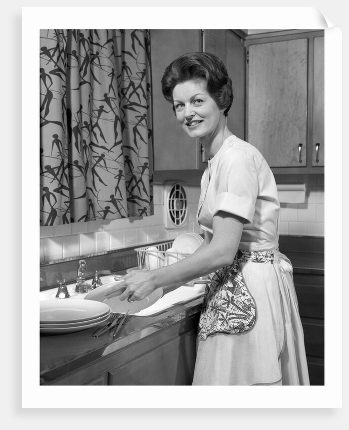 1960s woman housewife washing dishes in kitchen sink looking at camera by Anonymous