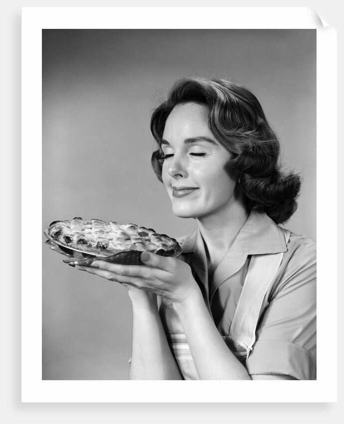 1950s 1960s woman smelling aroma of freshly baked pie by Anonymous
