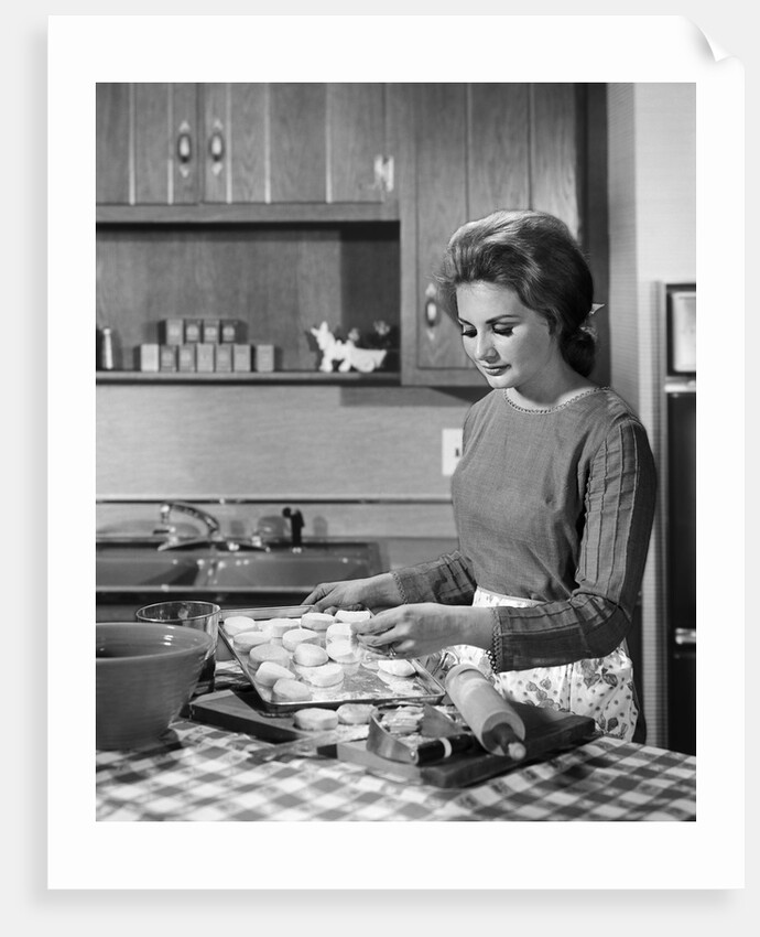 1960s woman housewife baking biscuits in kitchen by Anonymous