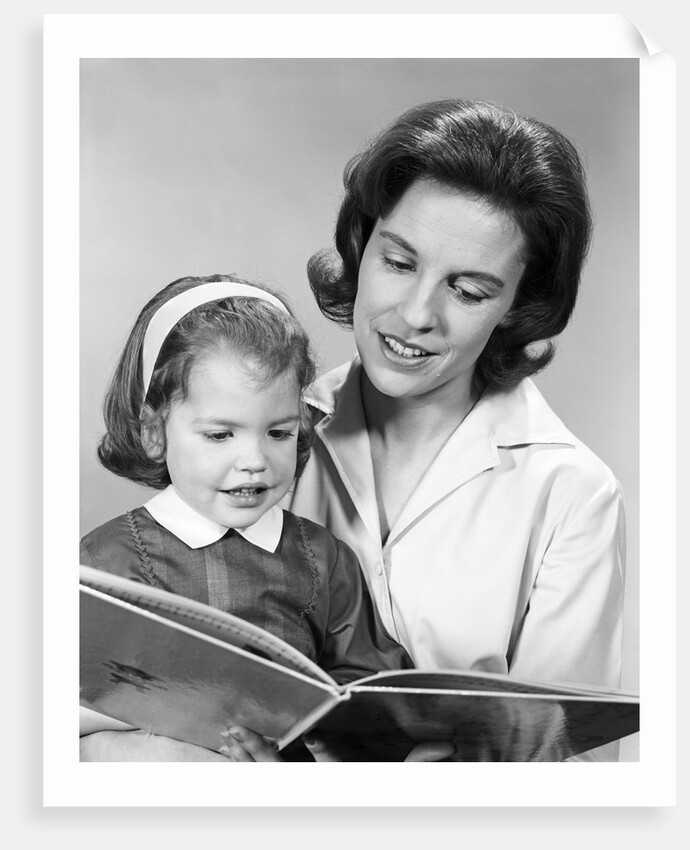 1960s woman reading story book to girl child by Anonymous