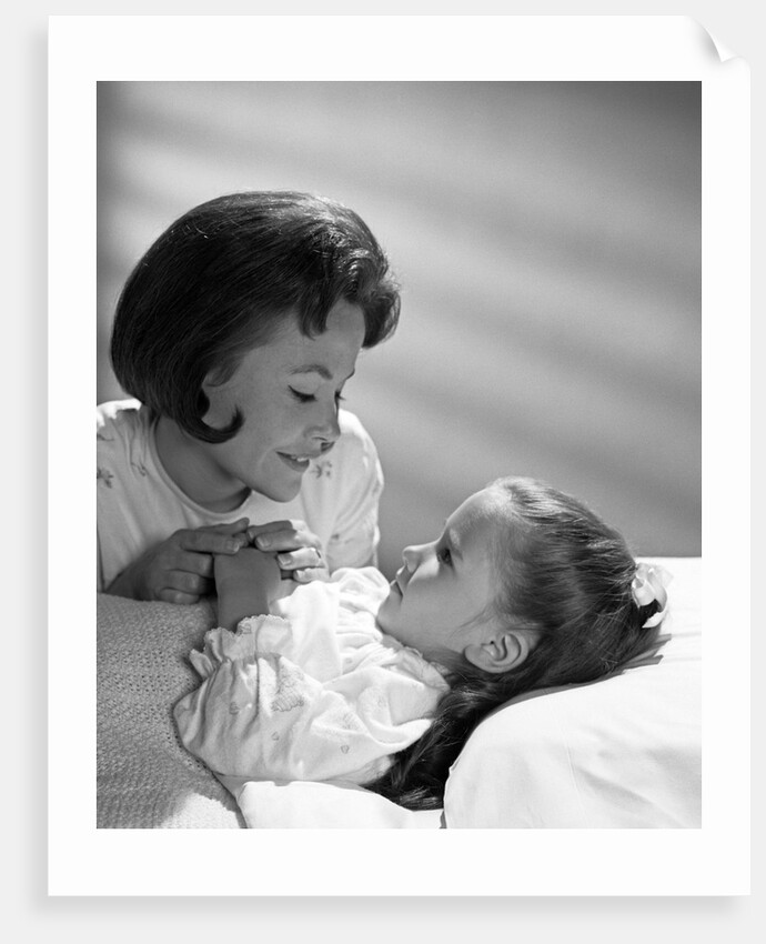 1960s daughter with mother tucking into bed by Anonymous