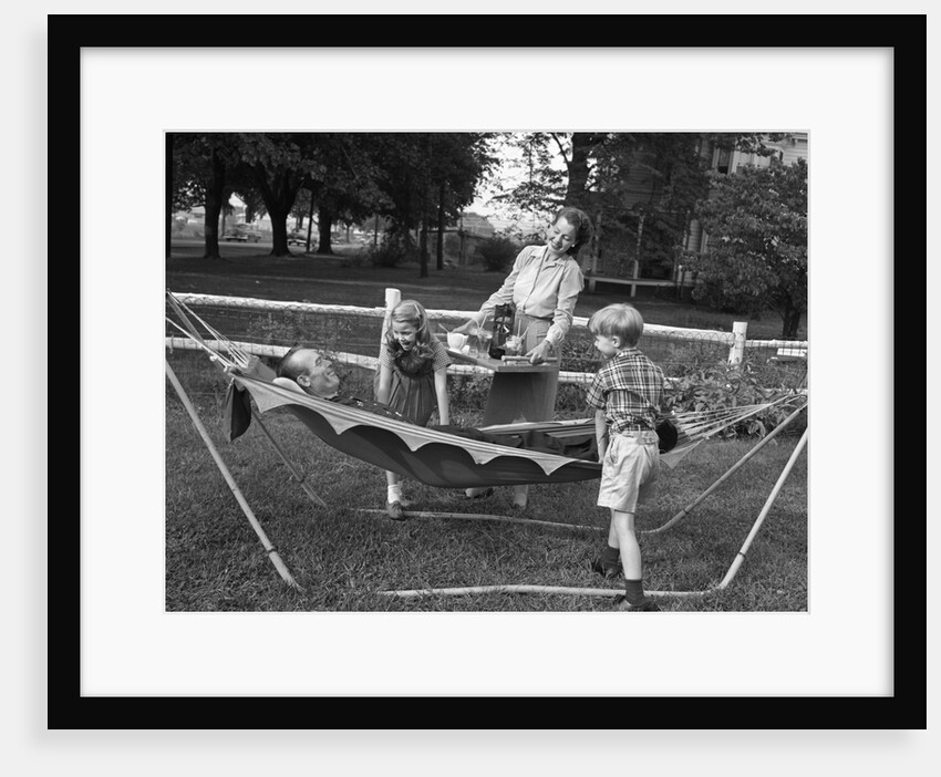 1950s mom & kids serving dad in hammock by Anonymous