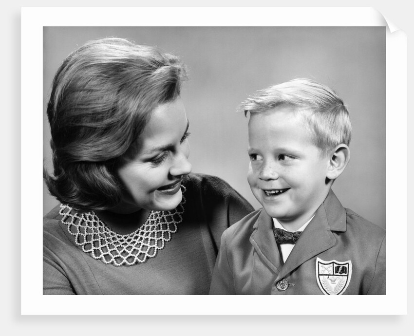 1960s portrait mother with arm around son dressed in school uniform with bow tie & emblem crest on jacket mom pearl lace collar by Anonymous