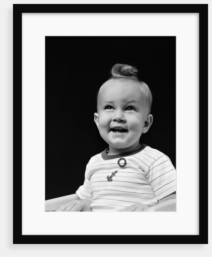 1940s smiling blond boy with big curl on top of head looking up by Anonymous