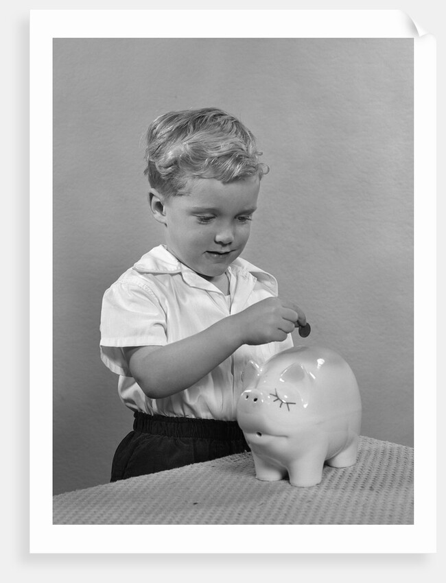 1950slittle boy putting coin into piggy bank by Anonymous