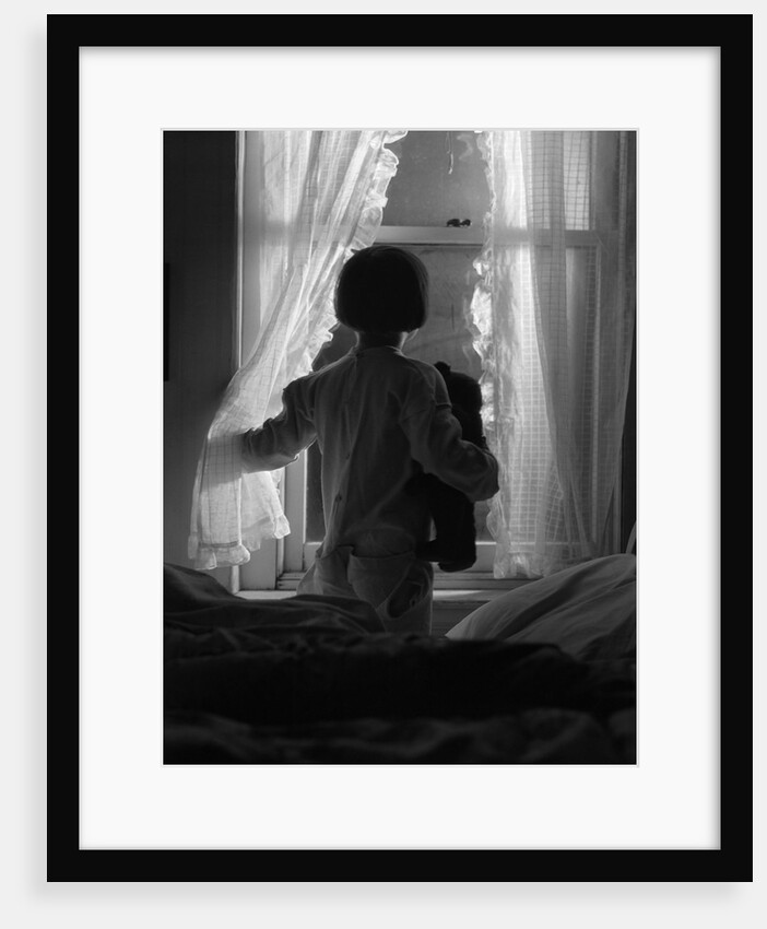 1920s child looking out window at night by Anonymous