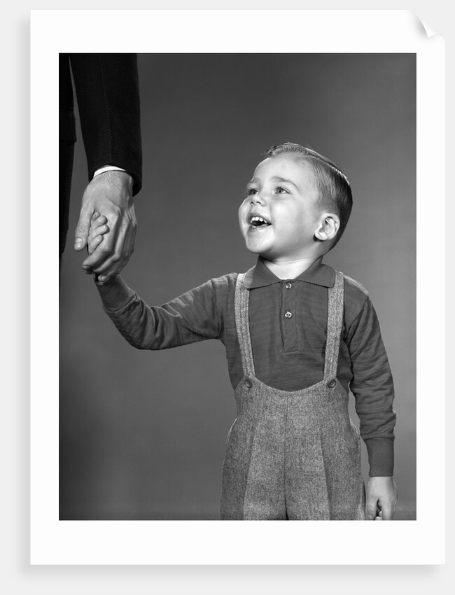 1960s boy holding adult male hand smiling by Anonymous