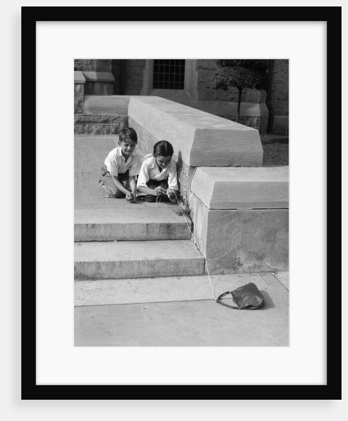 1930s two boys playing trick with string tied to lost purse by Anonymous