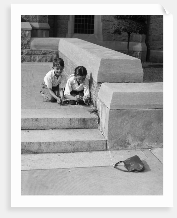 1930s two boys playing trick with string tied to lost purse by Anonymous