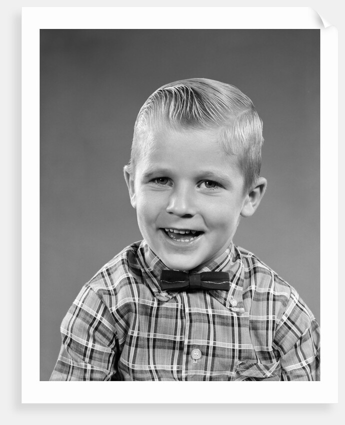 1950s smiling blond boy wearing plaid shirt bow ties looking at camera by Anonymous