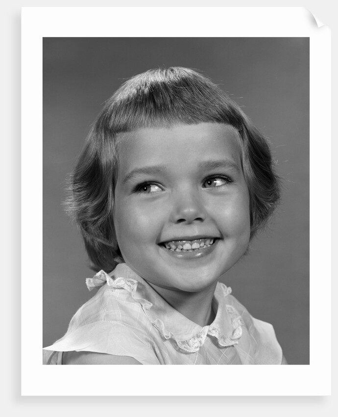 1960s smiling girl looking off to the side by Anonymous