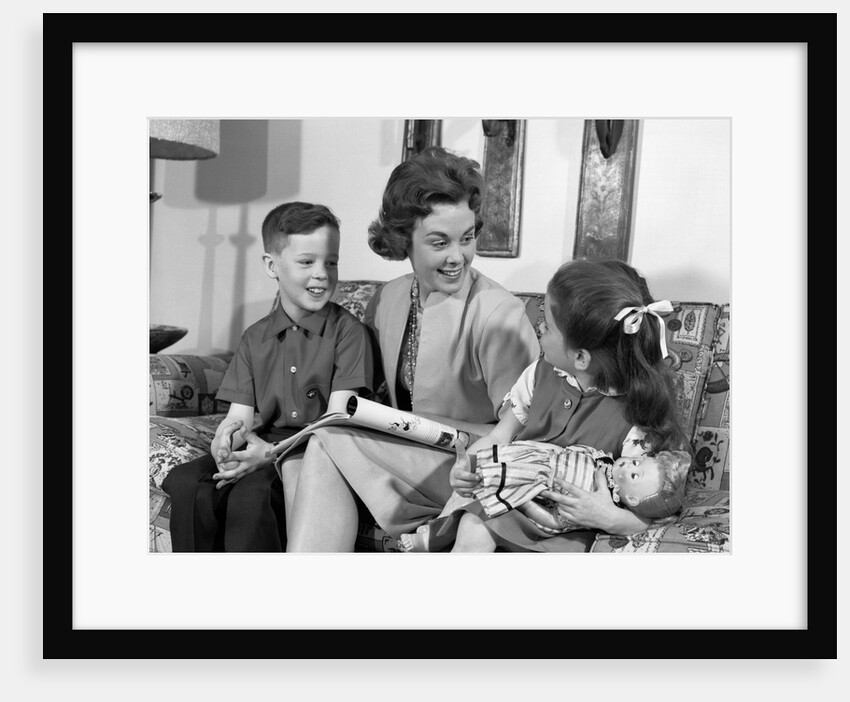 1960s mother sitting on couch with son and daughter by Anonymous