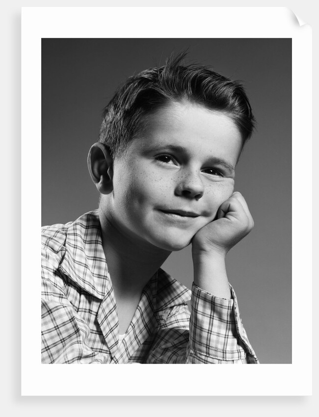 1950s child portrait boy with freckles posed resting head cheek on hand by Anonymous