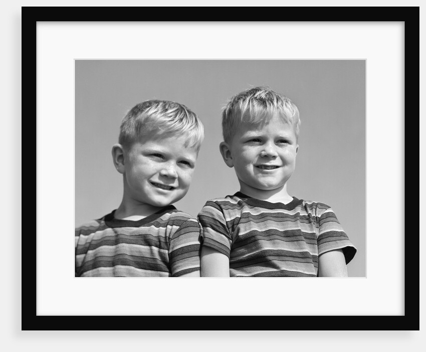 1950s portrait two twin blond boys smiling wearing striped tee shirts brothers by Anonymous