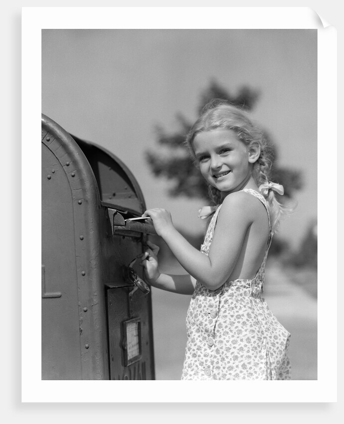 1930s 1940s child blond little girl with pigtails putting letter into mail box, looking at camera by Anonymous