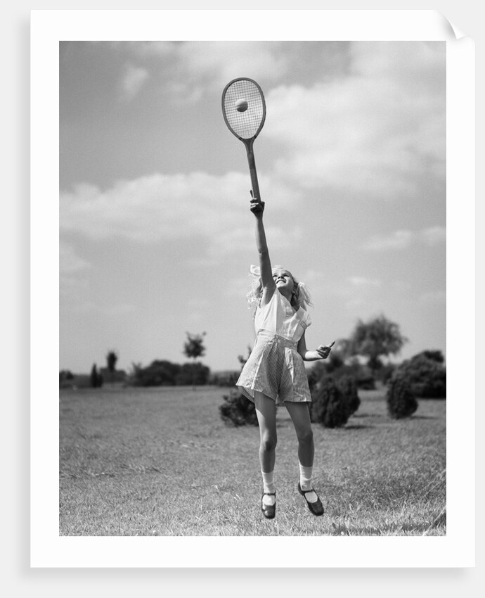 1930s girl playing tennis jumping to hit ball overhead by Anonymous