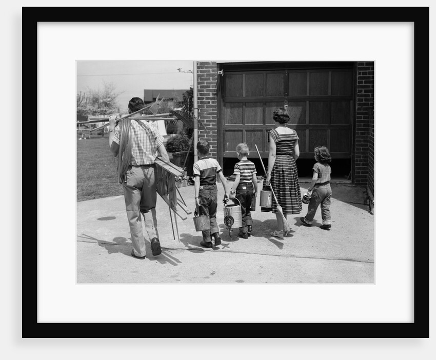 1950s family mother father 3 children from behind carrying gardening home improvement tools equipment by Anonymous