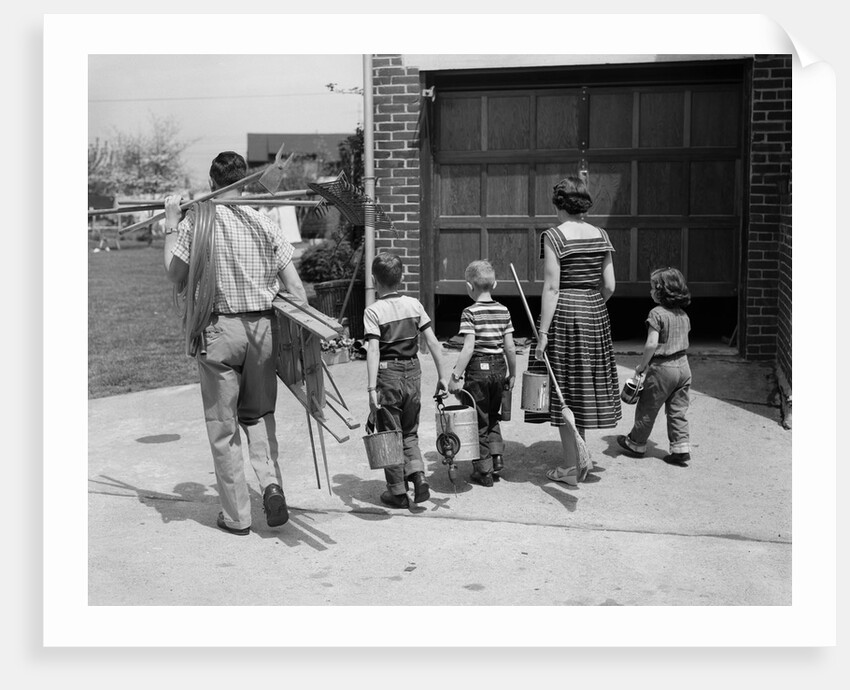 1950s family mother father 3 children from behind carrying gardening home improvement tools equipment by Anonymous
