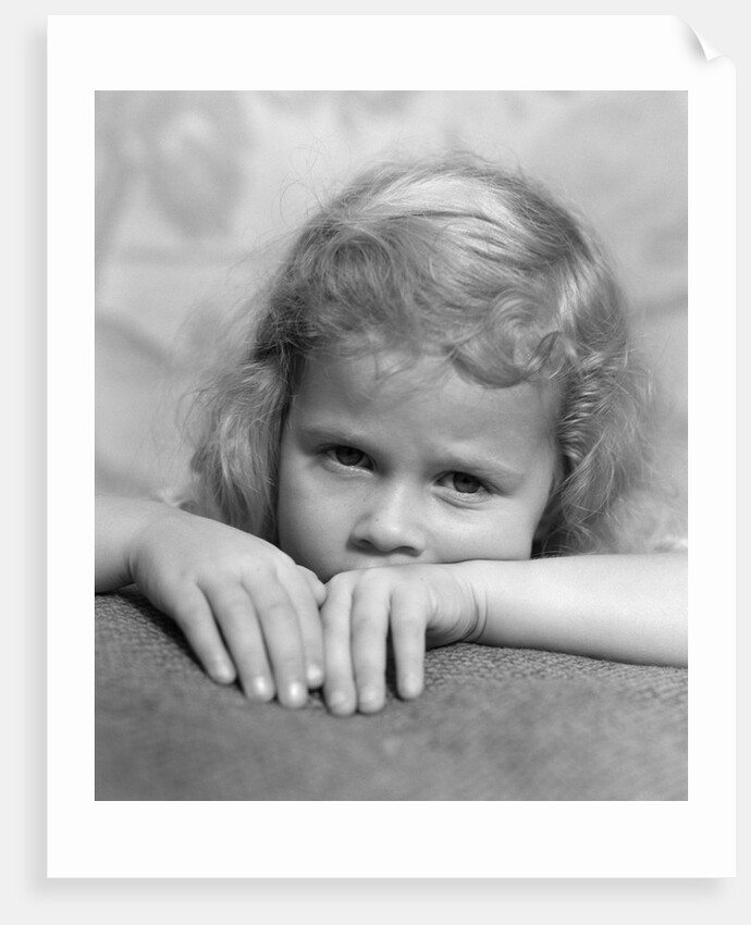 1930s portrait sad little blond girl peeking over her hands looking at camera by Anonymous