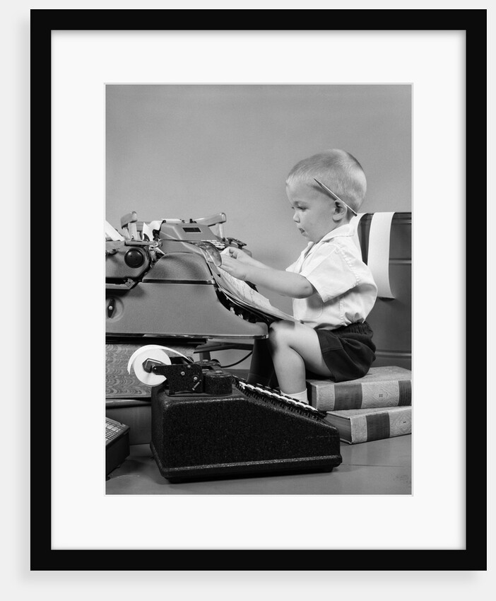 1950s child typing sitting at typewriter by Anonymous