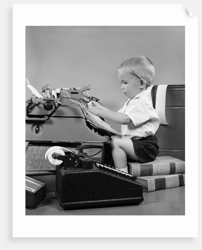 1950s child typing sitting at typewriter by Anonymous