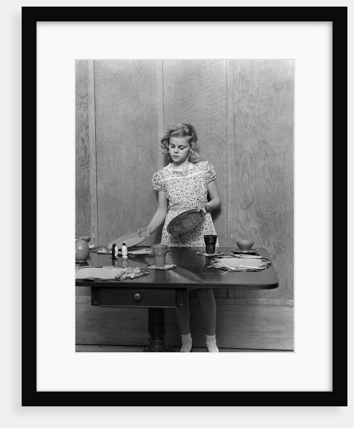 1940s blond pre-teen young woman setting table by Anonymous