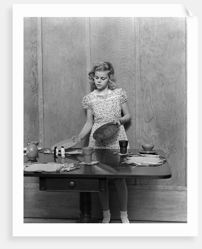 1940s blond pre-teen young woman setting table by Anonymous