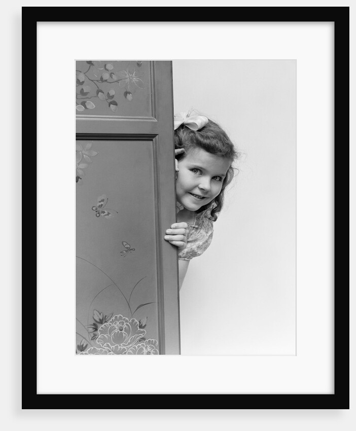 1940s child smiling little girl peeking around painted folding screen by Anonymous