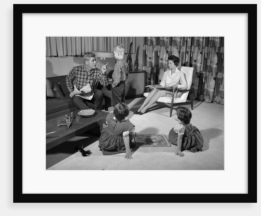 1960s family of four in living room boy is being disciplined by dad shaking finger by Anonymous