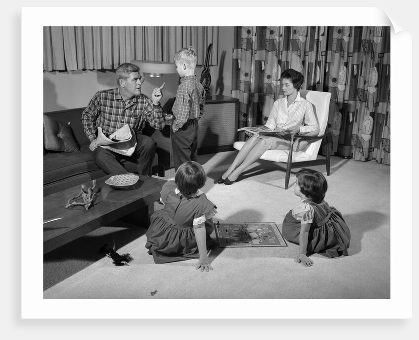 1960s family of four in living room boy is being disciplined by dad shaking finger by Anonymous