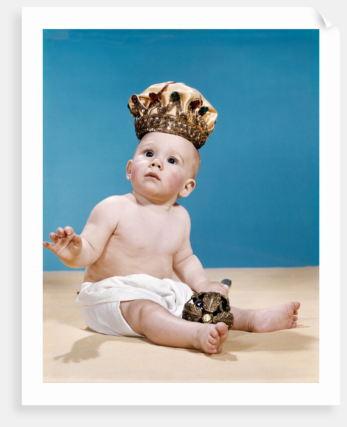 1960s baby wearing cloth diaper and crown holding a scepter by Anonymous