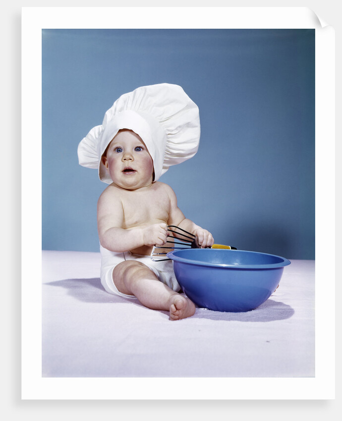 1950s 1960s baby wearing chef hat toque holding spatula blue mixing bowl by Anonymous