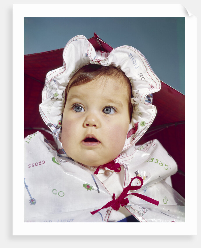 1960s baby wearing raincoat and hat by Anonymous